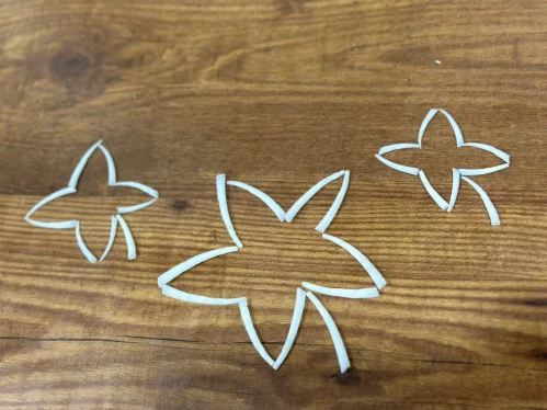 Star design templates on a wooden workspace for seashell craft ideas